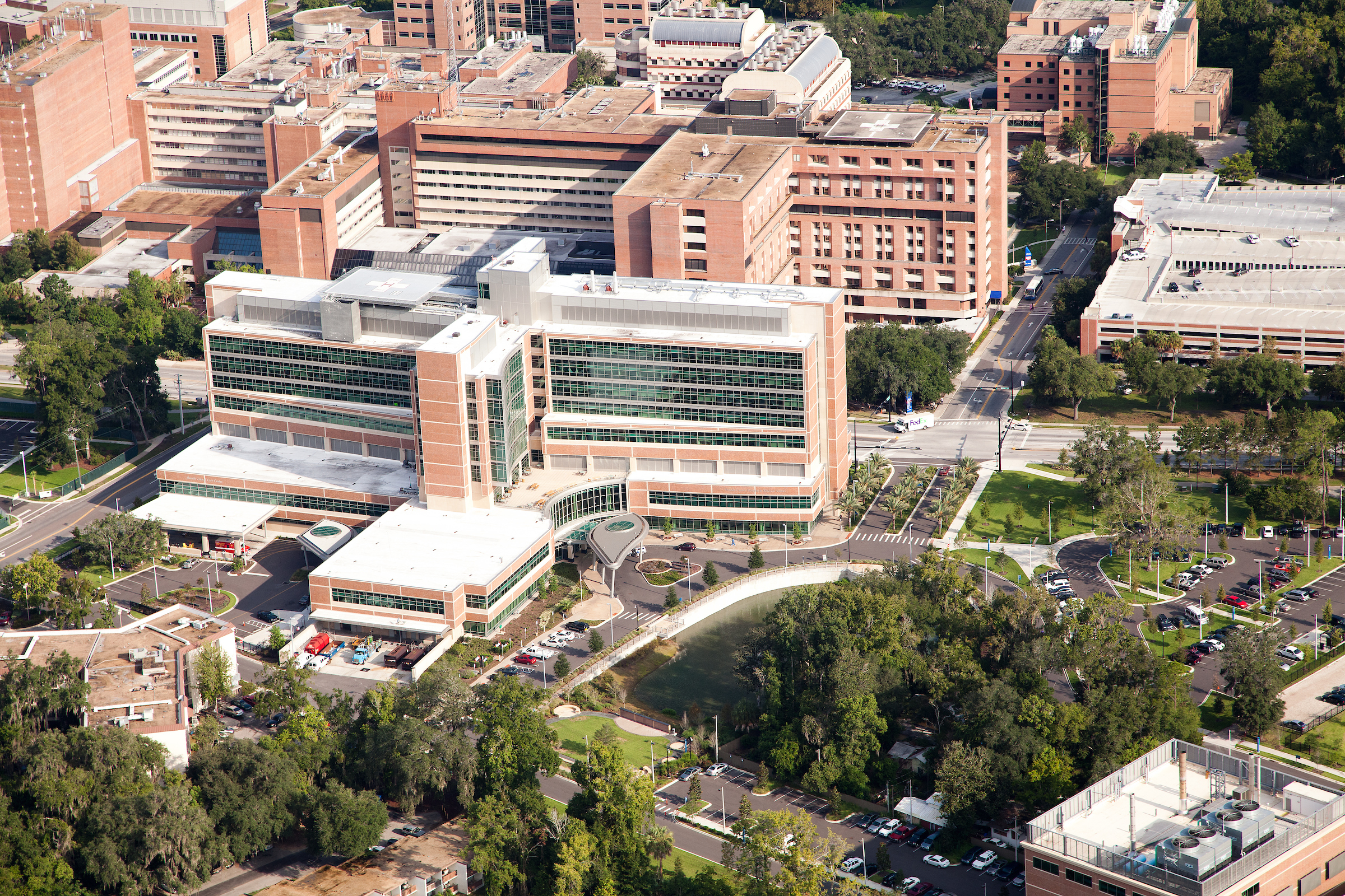 red brick UF Health Shand building from aerial view surrounded by green trees